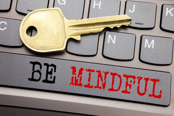 Hand writing text caption inspiration showing Be Mindful. Business concept for Mindfulness Healthy Spirit written on keyboard key on the with key next to the text.