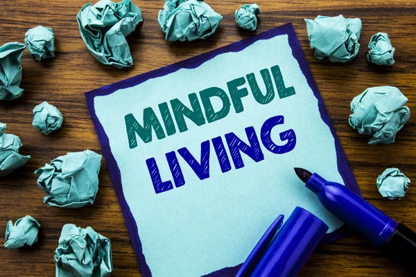 Writing text showing Mindful Living. Business concept for Life Happy Awareness Written on sticky note paper, wooden background with marker folded yellow paper meaning thinking