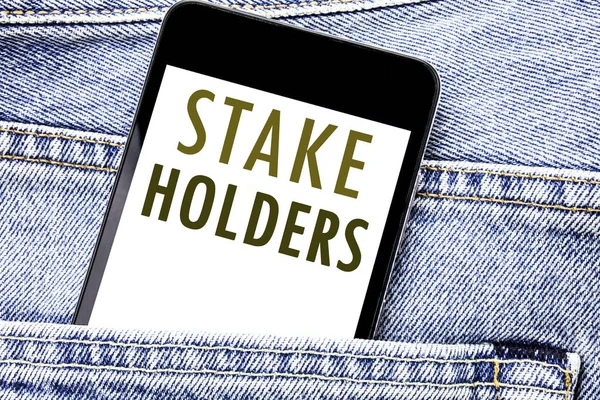 Handwriting Announcement text showing Stake Holders. Business concept for Stakeholder Engagement Written phone mobile phone, cellphone placed in the man front jeans pocket. — Stock Photo, Image