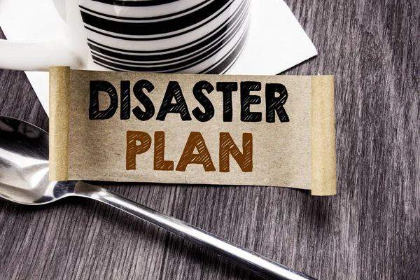 Handwriting Announcement text showing Disaster Plan. Business concept for Emergency Recovery written on sticky note paper on the wooden wood background. With marker and coffee. Office top view.