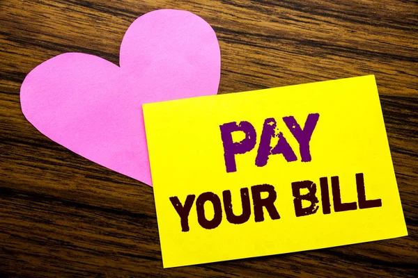 Hand writing text caption inspiration showing Pay Your Bill. Business concept for Payment for Goverment written on sticky note paper, wooden wood background. With pink heart meaning love adoration. — Stock Photo, Image