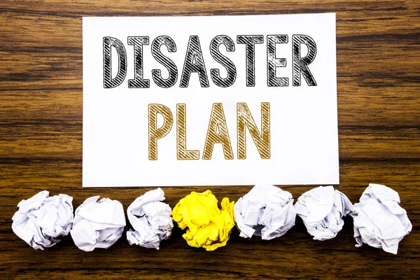 Word, writing Disaster Plan. Concept for Emergency Recovery Written on sticky note paper reminder, wooden background with sticky, one folded paper alone for difference or collaboration