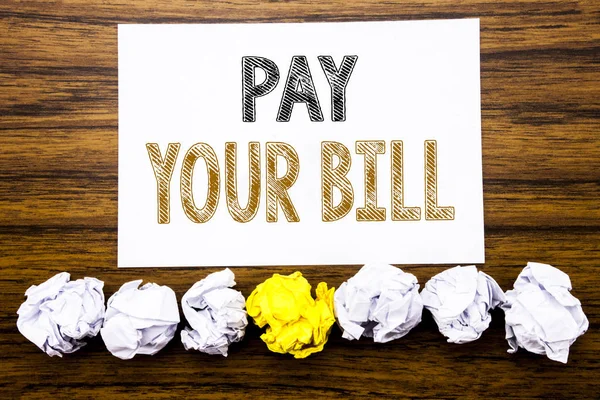 Word, writing Pay Your Bill. Concept for Payment for Goverment Written on sticky note paper reminder, wooden background with sticky, one folded paper alone for difference or collaboration — Stock Photo, Image