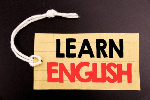 Word, writing Learn English. Business concept for online sale Language School written on price tag paper on the black vintage background.