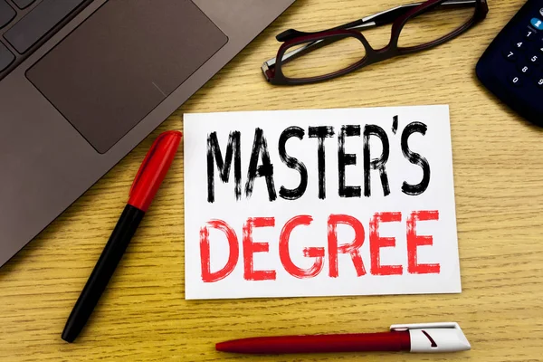 Conceptual hand writing text showing Master s Degree. Business concept for Academic Education written on paper, wooden background in office with copy space, marker pen and glasses