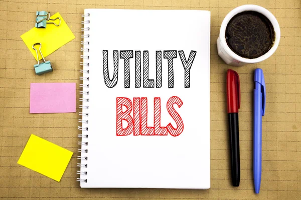 Word, writing Utility Bills. Business concept for Money Bill Payment Written on notepad note paper background with space office view with pencil marker coffee