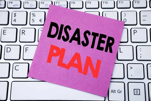 Handwriting Announcement text showing Disaster Plan. Business concept for Emergency Recovery written on sticky note paper on the white keyboard background.