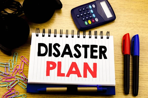 Conceptual hand writing text caption showing Disaster Plan. Business concept for Emergency Recovery written on notebook book on the wooden background in Office with laptop coffee