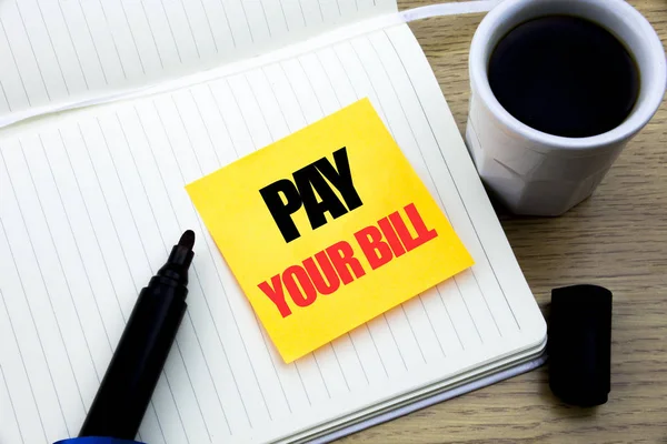 Hand writing text caption inspiration showing Pay Your Bill. Business concept for Payment for Goverment written on sticky note paper, Wooden background with space, Coffee and marker — Stock Photo, Image