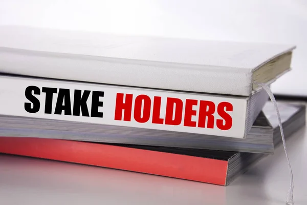 Writing text showing Stake Holders. Business concept for Stakeholder Engagement written on the book on the white background. — Stock Photo, Image