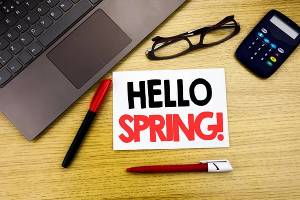 Handwritten text caption showing Hello Spring . Business concept writing for Summer Time Welcoming written on paper, wooden background in office with space, marker pen and glasses — Stock Photo, Image