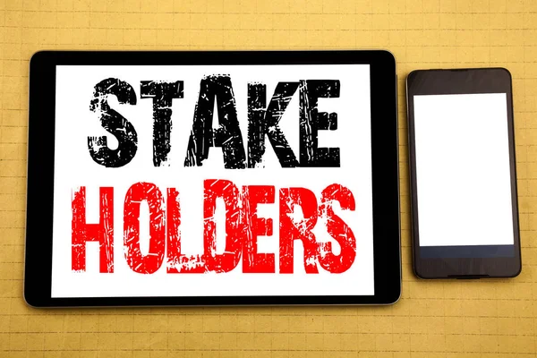Hand writing text caption inspiration showing Stake Holders. Business concept for Stakeholder Engagement Written on tablet laptop, wooden background with sticky note, coffee and pen — Stock Photo, Image