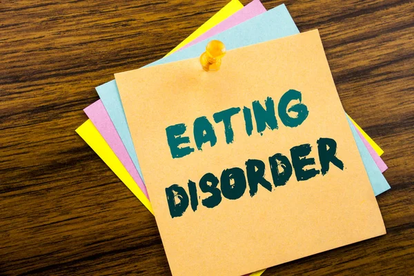 Hand writing text caption inspiration showing Eating Disorder. Business concept for Medical Problem written on sticky note paper on the wooden background. — Stock Photo, Image