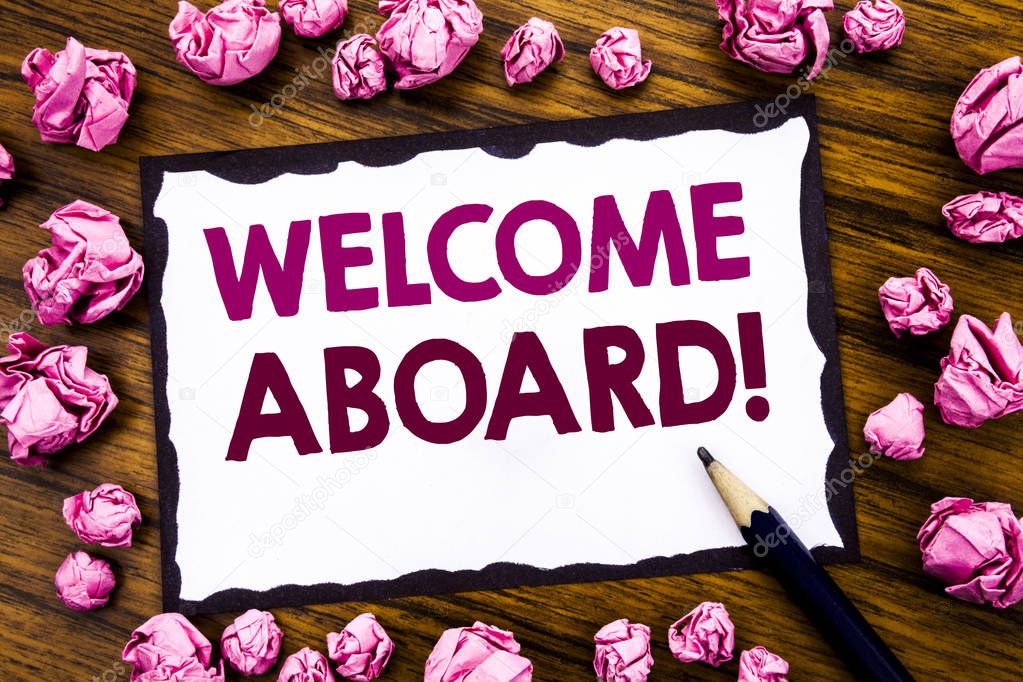 Hand writing text caption inspiration showing Welcome Aboard. Business concept for Greeting Join Member Written on sticky note paper, wooden background with folded pink paper meaning thinking