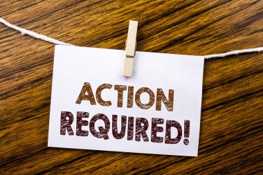 Gereken eylem gösteren el yazısı duyuru metin. İş kavramı için yapışkan not kağıdına ahşap arka plan üzerinde yazılı acil acil.