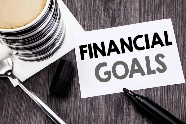 Handwriting Announcement text showing Financial Goals. Business concept for Income Money Plan written on sticky note paper on the wooden wood background. With marker and coffee. Office top view. — Stock Photo, Image