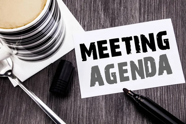 Handwriting Announcement text showing Meeting Agenda. Business concept for Business Schedule Plan written on sticky note paper on the wooden wood background. With marker and coffee. Office top view. — Stock Photo, Image