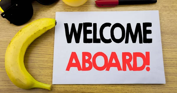 Welcome Aboard. Business concept for Greeting Join Member written on sticky note empty paper, wooden background with copy space, sunglasses and banana
