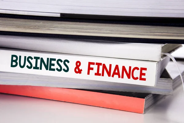 J'écris Business And Finance. Concept d'entreprise pour la stratégie d'entreprise écrit sur le livre sur le fond blanc . — Photo