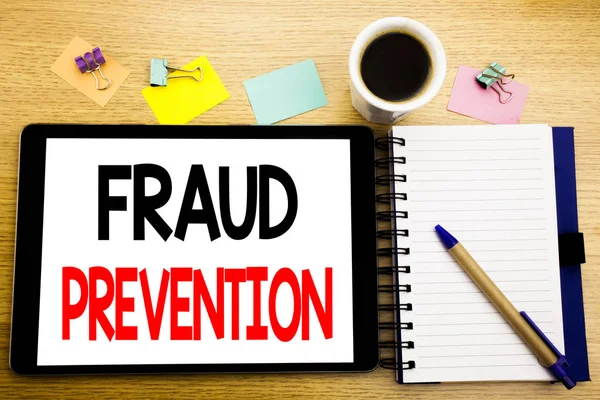 Word, writing Fraud Prevention. Business concept for Crime Protection Written on tablet laptop, wooden background with sticky note, coffee and pen