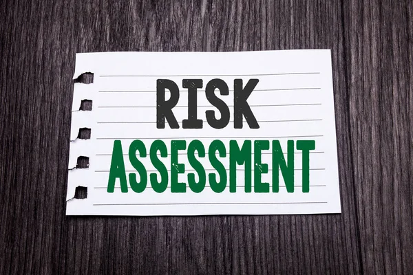 Word, writing Risk Assessment. Business concept for Safety Danger Analyze written on sticky note paper on the dark wooden background. Black and green.