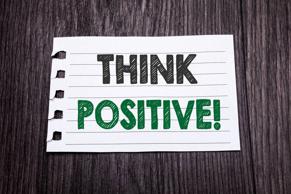 Word, writing Think Positive. Business concept for Positivity Attitude written on sticky note paper on the dark wooden background. Black and green.