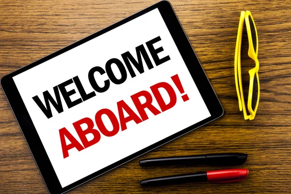 Writing text showing Welcome Aboard. Business concept for Greeting Join Member Written on tablet laptop, wooden background with vacation yellow glasses and marker pen.