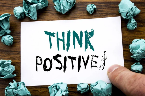 Escrita à mão Texto de anúncio mostrando Think Positive. Conceito de negócio para Positividade Atitude Escrito em papel de nota pegajosa, fundo de madeira com papel amarelo dobrado significando pensamento — Fotografia de Stock