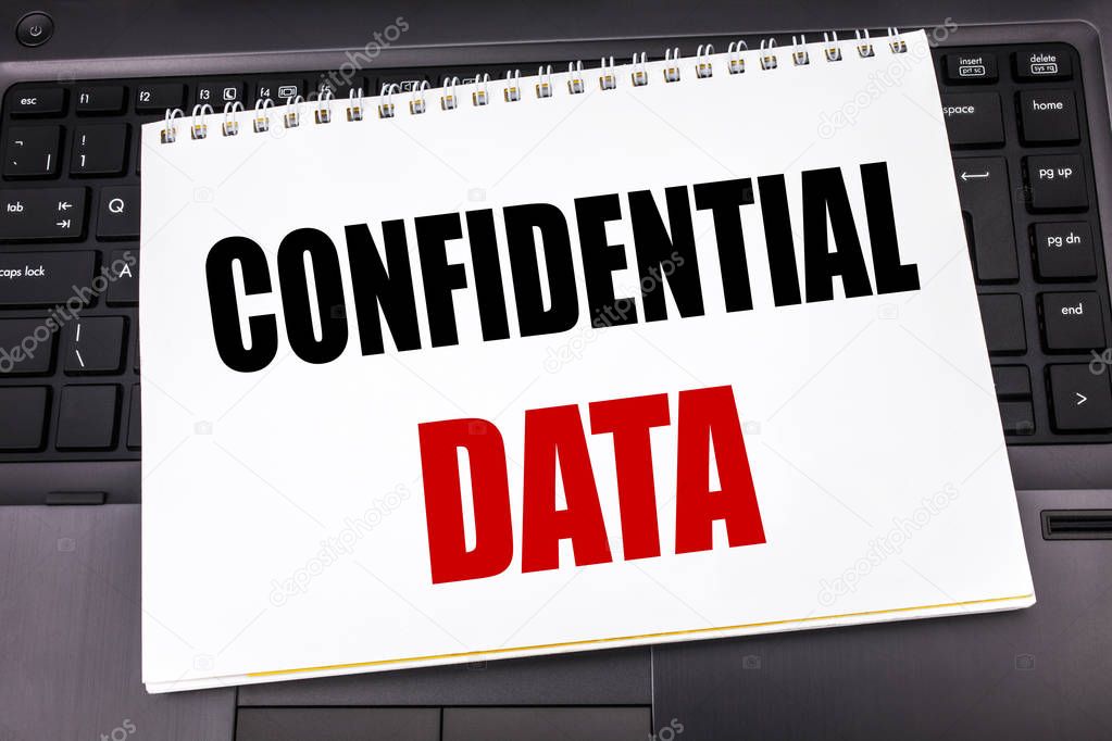Handwritten text showing Confidential Data. Business concept writing for Secret Protection written on notepad note paper on the black keyboard background.