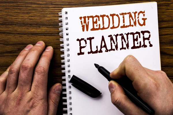 Handwritten text showing word Wedding Planner. Business concept for Marriage Preparation Written on tablet laptop, wooden background with businessman hand, finger writing on notebook book. — Stock Photo, Image