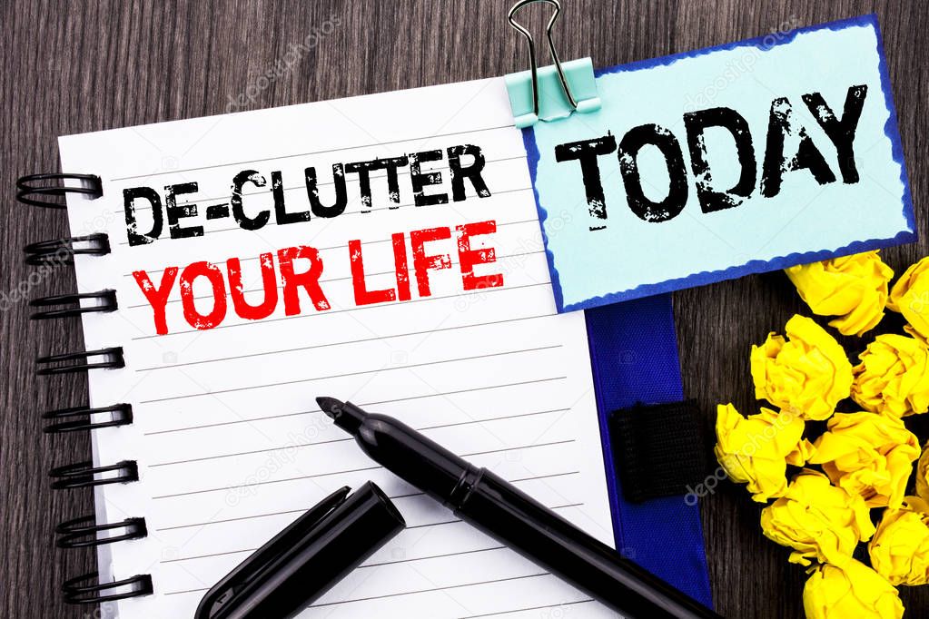 Writing text showing  De-Clutter Your Life. Business photo showcasing Free Less Chaos Fresh Clean Routine written on notebook book paper on the wooden background Today