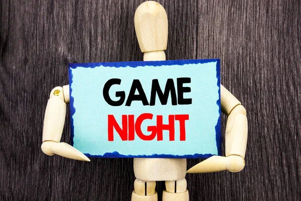 Writing text showing  Game Night. Concept meaning Entertainment Fun Play Time Event For Gaming written on Sticky Note Holding By Sculpture on the wooden background. — Stock Photo, Image