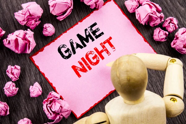 Conceptual hand text showing Game Night. Concept meaning Entertainment Fun Play Time Event For Gaming written on Sticky Note Holding By Sculpture on the wooden background. — Stock Photo, Image