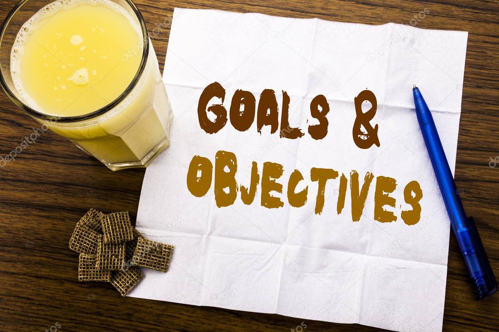 Handwriting Announcement text showing Goals Objectives. Business concept for Plan Success Vision written on tissue paper on the wooden background with pen and healthy juice in the restaurant