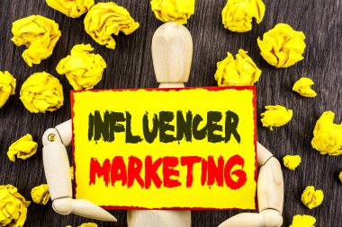 Influancer pazarlama gösteren duyuru metin. Sosyal Medya Online etkisi yapışkan not Holding tarafından heykel üzerinde ahşap arka plan üzerinde yazılı stratejisi anlam kavramı