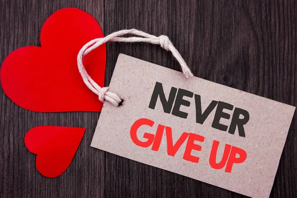 Handwriting Announcement text showing Never Give Up. Business concept for Motivation Quote For Success Achievement Challenge written on Price tag with Red words on the wooden background. — Stock Photo, Image