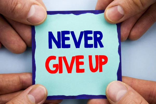 Handwriting Announcement text showing Never Give Up. Business photo showcasing Motivation Quote For Success Achievement Challenge written on Sticky Note Paper Holding Hand with Finger. — Stock Photo, Image