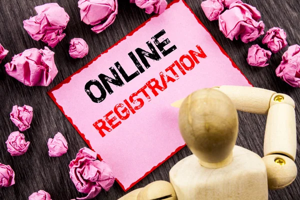 Conceptual hand text showing Online Registration. Concept meaning Register Web Subscription Subscribe written on Sticky Note Holding By Sculpture on the wooden background.