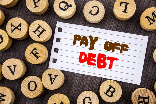 Word, writing, text  Pay Off Debt. Conceptual photo Reminder To Paying Owed Financial Credit Loan Bills written on tear notobook paper on the wooden background with letters.