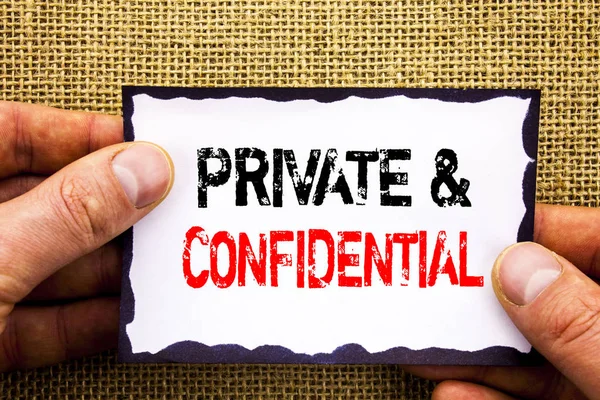 Writing text showing  Private And Confidential. Concept meaning Security Secret Sensitive Classified Information written on Sticky Note Paper Holding Hand with Finger. — Stock Photo, Image