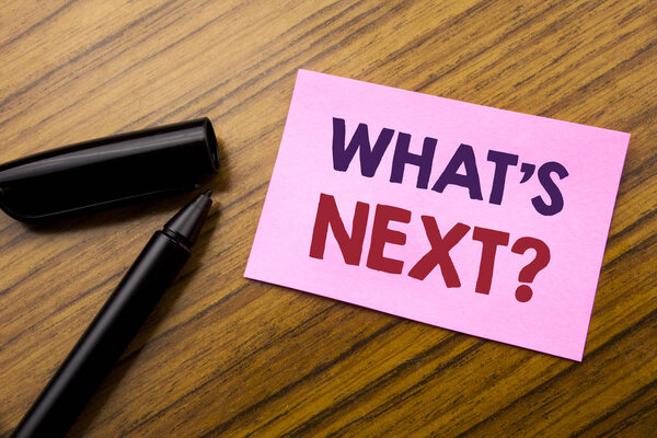 Word, writing What is Next Question. Business concept for Next Future Plan Vision Progress Goal Guidance Written on sticky note red paper, wooden background with pen. Note stick on the desk.