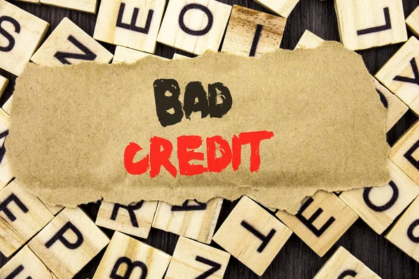 Handwriting Announcement text showing Bad Credit. Concept meaning Poor Bank Rating Score For Loan Finance written on tear paper note on the letter and wood background.