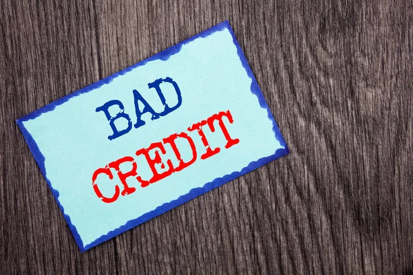 Writing text showing  Bad Credit. Business photo showcasing Poor Bank Rating Score For Loan Finance written on Blue Sticky Note Paper on the wooden background.
