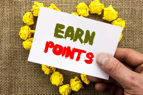 Handwritten text sign showing Earn Points. Conceptual photo Loyalty Reward Benefit Program For Earning Customer Point written on Sticky Note Paper With Heart Holding Hand with Finger.