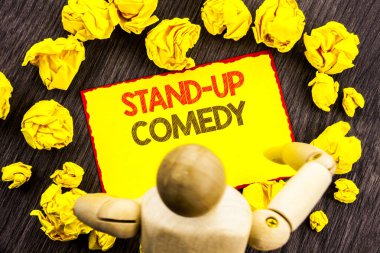 Komedi Stand Up gösterilen metin yazma. Eğlence eğlenceli göstermek komedyen yapışkan not Holding tarafından heykel üzerinde ahşap arka plan üzerinde yazılı gece kulübü vitrine iş fotoğraf