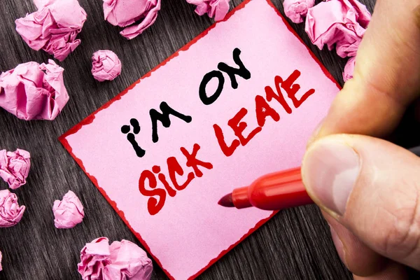 Text sign  I m am On Sick Leave. Business concept for Vacation Holiday Absent Out Of Office Sickness Fever written Pin Sticky Note Paper Folded Paper the wooden background Man Holding Marker Hand