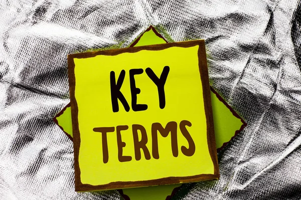 Text sign showing Key Terms. Conceptual photo Key Plan Strategy Performance Vision Goal Policy Concept Firm written on Stacked Sticky Note Paper on the Silver textured background.