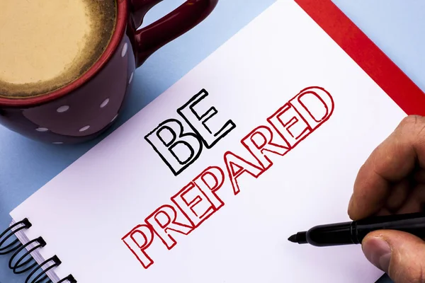Writing note showing  Be Prepared. Business photo showcasing Preparedness Challenge Opportunity Prepare Plan Management written on Notebook Book Holding Pen on the plain background Coffee Cup. — Stock Photo, Image