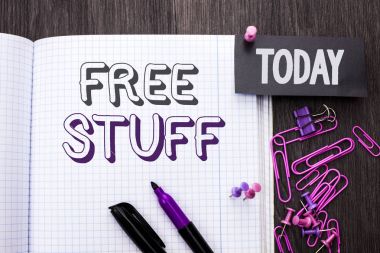 Handwriting text Free Stuff. Concept meaning Complementary Free of Cost Chargeless Gratis Costless Unpaid written on Notebook Book on wooden background Today with Thumbpin Marker Paper Clip. clipart
