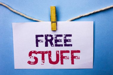 Text sign showing Free Stuff. Conceptual photo Complementary Free of Cost Chargeless Gratis Costless Unpaid written on White Note Paper hanging with rope on the plain background Clip. clipart